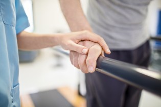 nurse hand on patient hand when a patient needs helps