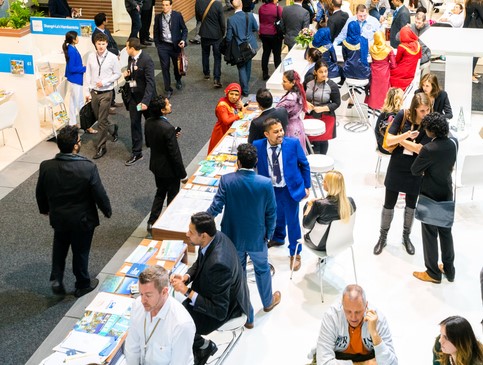 participants at a dental conference on the floor in the exhibit hall