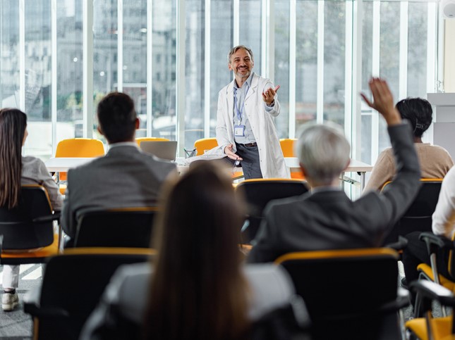 dentist leading a session at a dental conference 