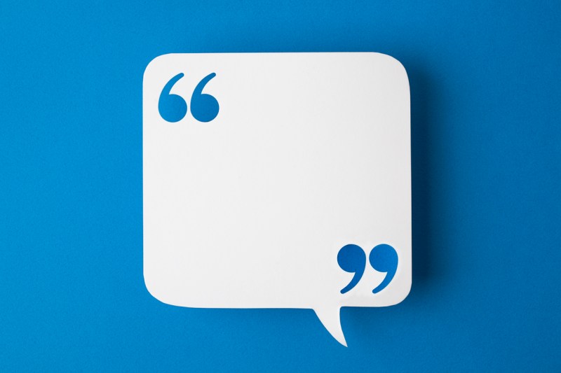 White square speech bubble with quotation marks in opposite corners against royal blue background.