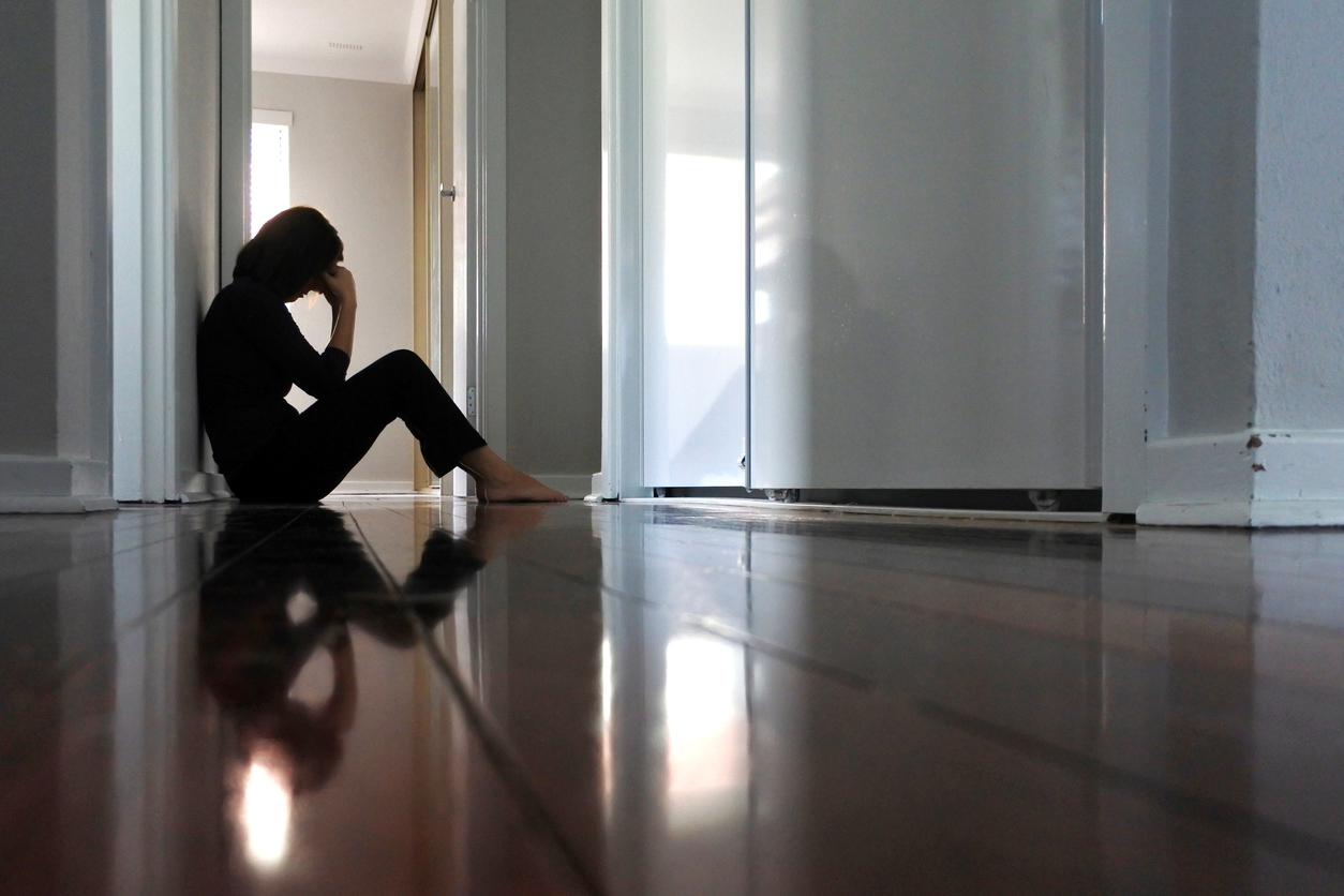 Nurse sitting against the wall after being sued for a wrongful resuscitation 