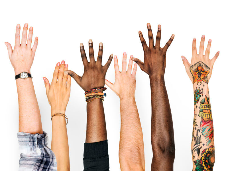 group of diverse hands reaching up