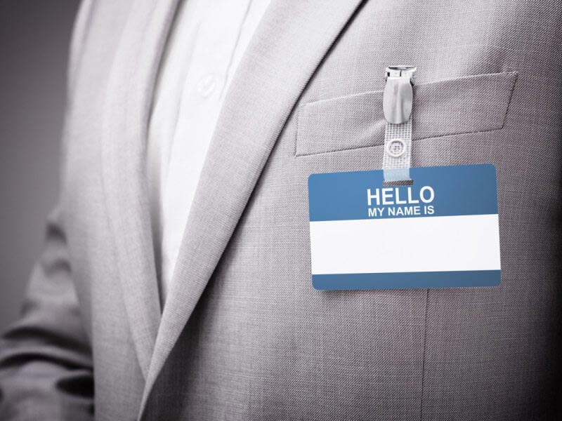 blank name tag on man