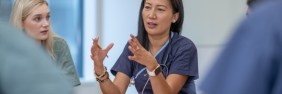 nurses in scrubs explaining nursing malpractice insurance