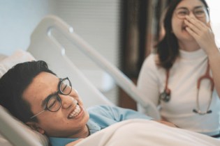 nurse and patient laughing in the hospital