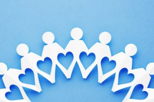 paper dolls on blue background making a heart