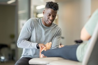 physical therapist assessing foot injury | best physical therapy blogs