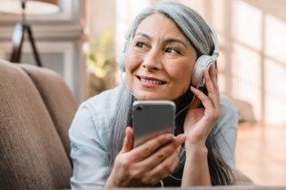 woman listening to best podcasts for therapists on phone