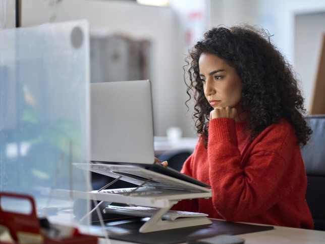 woman looking on computer at claims made vs occurrence policies