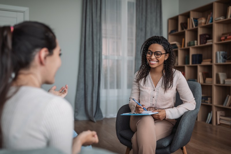 female therapist or psychologist talking with a client in the therapist's office