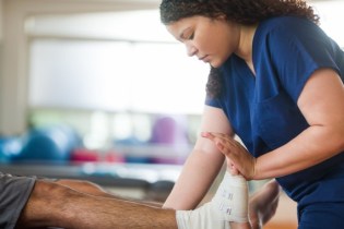 physical therapists working on a client in their practice