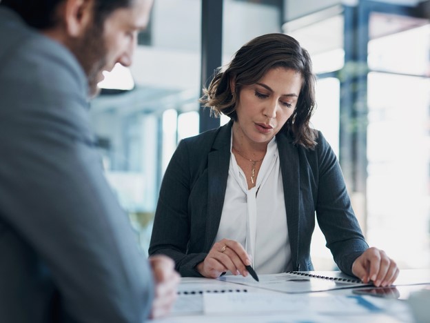 Woman and man choosing liability insurance on a table